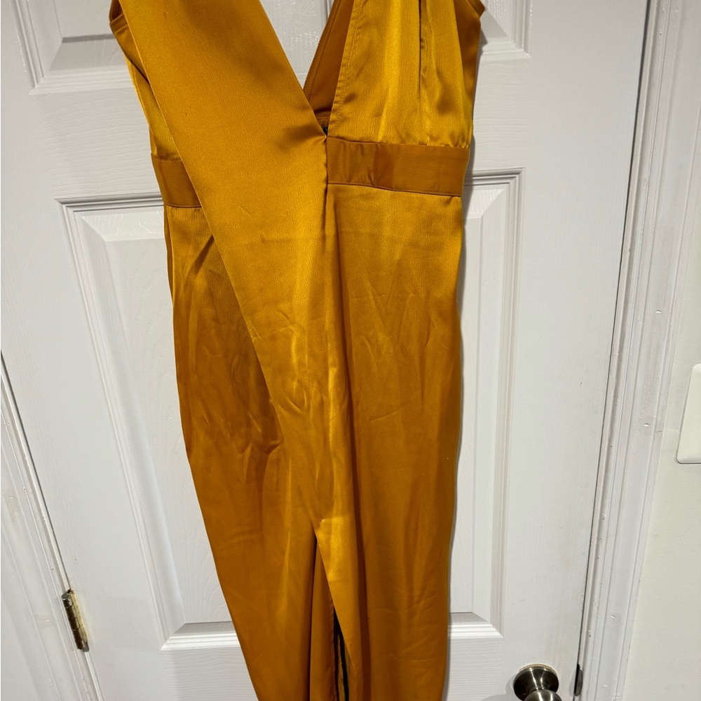 This beautiful gold one shoulder dress with slit in front is the perfect dress.